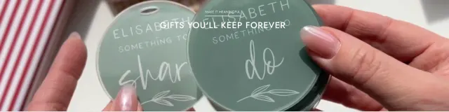 Hands holding two personalised green gift tags from Arlo & Co